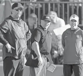  ?? BRYAN TERRY/THE OKLAHOMAN ?? OSU coach Kenny Gajewski and OU coach Patty Gasso talk with an official before Thursday's Bedlam softball game in Norman.