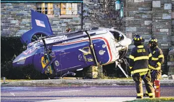  ?? MATT ROURKE AP ?? A medical helicopter rests next to the Drexel Hill United Methodist Church after it crashed Tuesday in Upper Darby, Pa. Authoritie­s and a witness say the pilot somehow avoided hitting power lines and buildings.