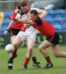  ??  ?? Tinahely’s Stephen Dillon gets his shot away despite the attention of Coolkenno’s Willie Doyle.