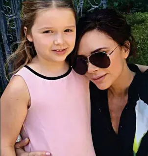  ??  ?? Under mummy’s wing: Victoria Beckham with daughter Harper