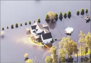  ?? Alex Wroblewski / Bloomberg ?? A home surrounded by floodwater is seen in this aerial photograph taken above Kinston, N.C., on Friday. Record floods cover much of eastern North Carolina in the wake of Hurricane Florence, and the waters are still rising.