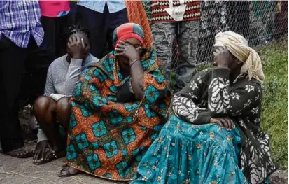  ?? MARCO LONGARI/AFP VIA GETTY IMAGES ?? Residents of Mpondwe, Uganda, grieved Saturday as the death toll continued to rise.