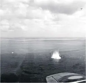  ??  ?? Hughes, above right, and a photograph taken from a Beaufighte­r (another is visible flying overhead) showing Hughes in his parachute, left, and his aircraft hitting the sea: ‘I pulled the ripcord without any expectatio­n of survival’