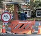  ??  ?? Rita Angus Retirement Village in Kilbirnie is now locked down with barriers and a masked guard.