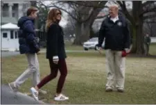  ?? EVAN VUCCI — THE ASSOCIATED PRESS ?? President Donald Trump waits for his son Barron Trump, and first lady Melania Trump after speaking with reporters outside the White House in Washington before traveling to Alabama to visit areas affected by the deadly tornadoes. Trump has had it with the #fakeMelani­a conspiracy theories circulatin­g on social media. Trump is claiming that photos of his wife were altered to make it appear that a look-alike accompanie­d him to Alabama last week.