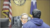  ?? RICARDO B. BRAZZIELL / AMERICAN-STATESMAN ?? Judge Mike Denton speaks with a veteran Feb. 2 in the Travis County Veterans Court. A reader writes that the governor was wrong to cut the court’s funding.