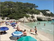  ?? ALBERT STUMM VIA AP ?? The beach at Cala Mitjana on the island of Menorca, Spain. The calm waters are great for snorkeling, and a cave off the side is easily explored.