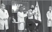  ?? ANDREW HARNIK/AP ?? Then-Surgeon General Jerome Adams gets a COVID-19 vaccine on Dec. 18, 2020.