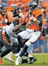  ?? JACK DEMPSEY/THE ASSOCIATED PRESS ?? Bengals defensive end Carlos Dunlap sacks Broncos quarterbac­k Brock Osweiler on Sunday in Denver. The Broncos lost, 20-17, to extend their losing streak to six games.
