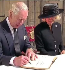  ?? ?? His royal nibs: King Charles signs a visitors’ book