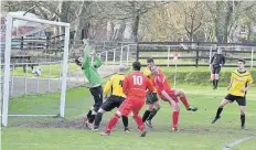  ??  ?? Glantraeth’s James Burgess (red) is in the thick of the action as the hosts score against Glan