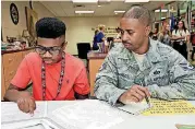  ?? [PHOTOS BY THOMAS MAUPIN, FOR THE OKLAHOMAN] ?? Braylon Charlot, 15, a freshman, looks over informatio­n with his father, Redd Charlot.