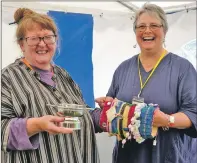  ??  ?? Mhairi MacKechnie is given her quaich by Mandy Boswell after success in the new craft for a cause section.