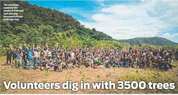  ?? ?? The volunteers celebrate the results of their hard work planting thousands of trees at Wonga Park.