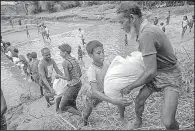  ?? AP/DAR YASIN ?? Rohingya Muslims move food from Burma across the border Friday into Bangladesh, where they have set up refugee camps in Tumbru.