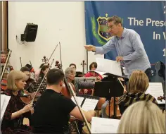  ??  ?? Wexford composer Liam Bates conducting the Wexford Sinfonia.