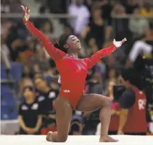  ?? Karim Jaafar / AFP / Getty Images ?? Simone Biles competes in the floor exercise final on the last day of the gymnastics world championsh­ips in Doha, Qatar.