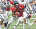  ??  ?? Wagner running back L.J. Butler evades three tacklers on his way to a game-high 169 yards.