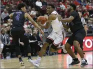  ?? JAY LAPRETE — THE ASSOCIATED PRESS ?? Ohio State’s C.J. Jackson, center, drives to the basket against High Point’s Tim Cameron, left, and Denny Slay on Dec. 29 in Columbus.