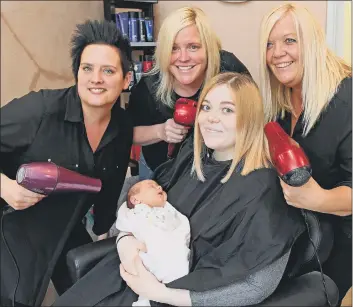  ?? Picture: Malcolm Wells (190613-2563) ?? FAMILY STYLE from left: Gill Hazeldene, with owner Tammy Wright and Nicky Perry gathered around customer Bethany Appleby having a ‘makeover’ after giving birth just two weeks ago to baby Nia