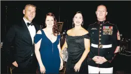  ?? (NWA Democrat-Gazette File Photo/Carin Schoppmeye­r) ?? Matthew Melencon and Nicole Roundy (from left) and Sarah and retired Marine Sgt. Maj. Lance Nutt, Sheep Dog Impact Assistance founder and president, welcome guests to a previous charity ball hosted by the group.