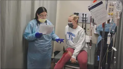  ?? (NWA Democrat-Gazette/Marc Hayot) ?? Crowder College nursing student Charlie Miller discusses the ‘injury’ suffered by Morgan Sprinkle during a mass casualty simulation on March 8 at John Brown University’s Health and Education building.