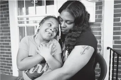 ?? ALGERINA PERNA/BALTIMORE SUN ?? Kelly Ellerbe and her daughter, Kelsey Hines, 6, outside their home. Kelsey made a video after she and her grandmothe­r had to take a detour due to a triple shooting. She pleaded and cried in the video for the killing to stop and for kids to be able to...