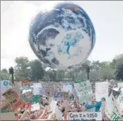  ?? AP ?? ■ AUSTRALIA: Protesters send up an inflatable globe in Sydney.