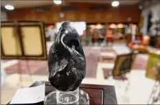  ??  ?? A meteorite from the estate of Paul Verbitsky is one of the items on display at the auction house.