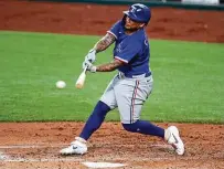  ?? Tony Gutierrez / Associated Press ?? Rangers outfielder Willie Calhoun connects in an intrasquad practice on Monday, the same day he injured his hip.