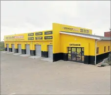  ?? Pictures: MARK ANDREWS ?? OPEN AND CLOSED: Above, Sicelo Mahlathi stands in front of workers outside his popular tyre business, which he took over from his father following his father’s death last year. The buzzing, informal one-stop tyre shop, situated at the Saule Building...