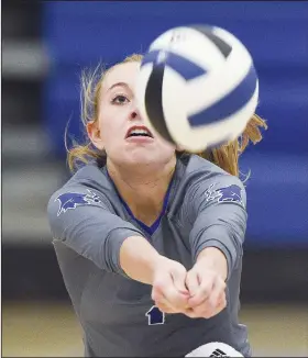  ?? NWA Democrat-Gazette/CHARLIE KAIJO ?? Rogers High School setter Camiran Brockhoff digs during a volleyball game on Thursday at King Arena at Rogers High School in Rogers.