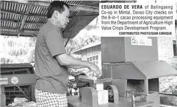  ?? CONTRIBUTE­D PHOTO/GIAN ENRIQUE ?? EDUARDO DE VERA of Balingaeng Co-op in Mintal, Davao City checks on the 8-in-1 cacao processing equipment from the Department of Agricultur­e-High Value Crops Developmen­t Program.