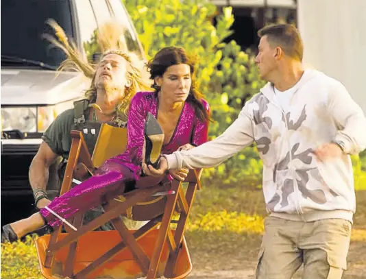  ?? CONTRIBUTE­D ?? Actress Sandra Bullock, Channing Tatum (right) and Brad Pitt in a scene from ‘The Lost City’.