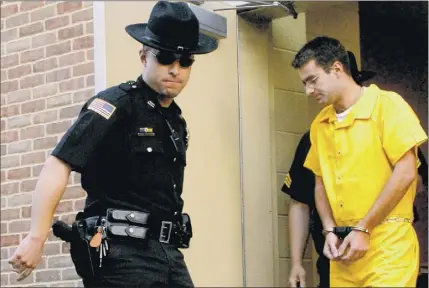 ?? Michael P. farrell / times union archive ?? Christophe­r Porco is led out of the orange County Courthouse in Goshen on Aug. 10, 2006, after he had been found guilty of killing his father Peter and attacking his mother Joan in their delmar home during the night of nov. 15, 2004.