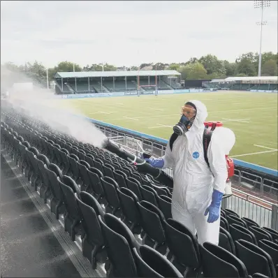  ?? PICTURES: PA ?? SPRAY: A liquid disinfecta­nt is blown on to seats at Saracens rugby union club, London, by a Rentokil Initial technician.