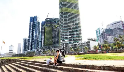  ??  ?? A foreign national and her child relax at the Galle Face green on Thursday as the city returned to normal business activities this week. Pic by M.A. Pushpa Kumara