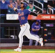  ?? John Minchillo / Associated Press ?? The Mets’ Eduardo Escobar runs home to score after hitting a solo home run against the Rangers on Saturday.