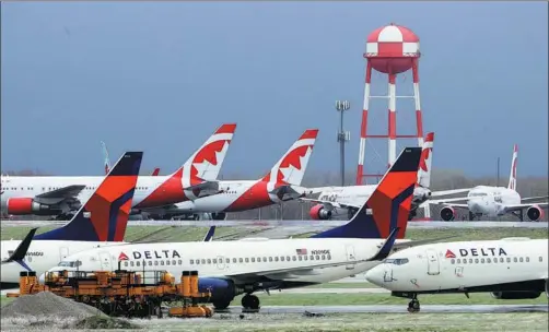  ?? GETTY IMAGES ?? Delta aircraft sit idle at Kansas City Internatio­nal Airport, the United States, on April 3.