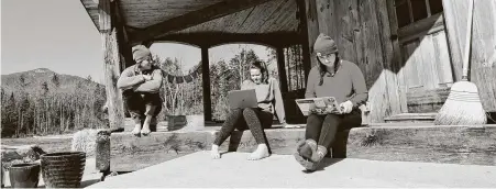  ?? Charles Krupa / Associated Press ?? Raven, center, a high school senior, and Willow, a freshman at Brandeis University, do classwork from home with limited internet.