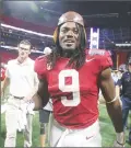  ?? Associated Press photo ?? Alabama running back Bo Scarbrough walks off the field with the Leather Helmet trophy after an NCAA football game against Florida State, Saturday in Atlanta.
