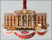  ?? (AP/Pablo Martinez Monsivais) ?? The White House Historical Associatio­n’s 2022 Christmas Ornament is seen Dec. 6 in Washington. The annual tree ornament this year honors President Richard M. Nixon’s administra­tion and a nod to first lady Pat Nixon who first put a gingerbrea­d house on display in the State Dining Room for the holiday season at the White House, long before its talented pastry chefs began making hundredpou­nd replicas of the executive mansion.