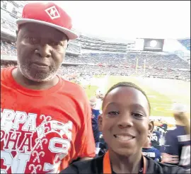  ??  ?? Florence attends a Bears game with his grandson Dylan Jones.