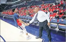  ?? Ole Miss assistant coach Win Case greets a player before the Rebels' Jan. 19 game against Arkansas. Case has many ties to Oklahoma, including as a player at OSU. ??