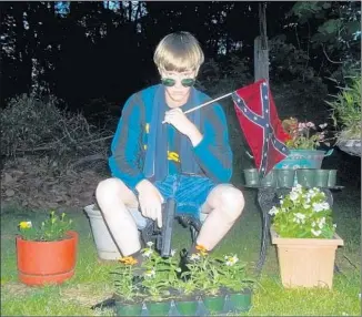  ??  ?? DYLANN ROOF posed for photos online with the Confederat­e flag. Protests after he was charged in the Charleston church massacre led to the f lag’s removal from South Carolina’s statehouse.