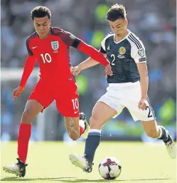  ??  ?? Kieran Tierney gets his pass away as England’s Dele Alli closes in during Saturday’s game at Hampden.