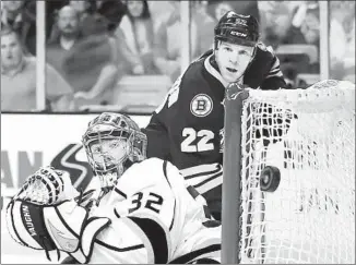  ?? Jared Wickerham
Getty Images ?? KINGS GOALIE Jonathan Quick watches puck shot by Boston’s Shawn Thornton (22) just miss the net. Kings Coach Darryl Sutter said of the game: “Our defense was not very good.”