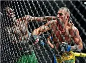  ?? AP ?? Brazil’s Alex Pereira, right, punches New Zealand’s Israel Adesanya during their middleweig­ht bout at the UFC 281 event in New York. Pereira stopped Adesanya in the fifth round.