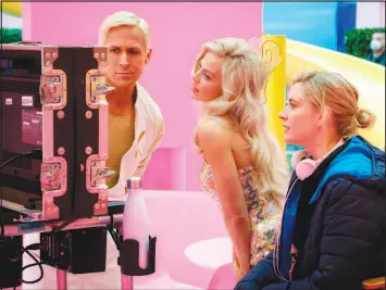  ?? JAAP BUITENDIJK / WARNER BROS. PICTURES VIA ASSOCIATED PRESS ?? Actors Ryan Gosling, left, and Margot Robbie, center, work with director Greta Gerwig on the set of “Barbie.” Robbie and Gerwig received Oscar snubs when nomination­s were released Tuesday. Robbie was snubbed for lead actress, while Gerwig was not nominated for best director of a film that grossed $1.4 billion at the box office.