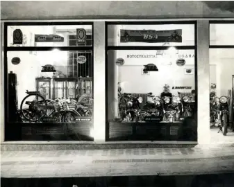  ??  ?? BELOW: You can just see Sofia Papoutsa at the desk (to left of right pillar) in this archive shot of the dealership